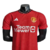 Camisa vermelha do Manchester United I 23/24, modelo jogador da Adidas, exibindo o logo da equipe e o patrocínio da Team Viewer.