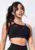 Top fitness cropped preto com detalhe transparente na parte frontal, usado por uma modelo feminina.