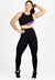 Conjunto de moda fitness composto por cropped preto com detalhes em roxo e calça legging preta com listras roxas.