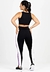 Modelo usando um conjunto de cropped preto com calça legging na cor preta, roxa e branca, visto de costas.
