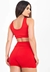 Modelo feminina usando um conjunto cropped e short vermelho com cadarço fake, visto de costas.