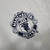 Camisa retrô branca do Manchester United II 1999/2000, manga longa, com detalhes em azul.