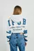 Buzo crop top crema oversize con capota y diseño college en internet