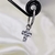 Colgante cruz con zircon