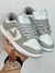 Tênis Nike Dunk Low Retro Cinza e Branco na internet