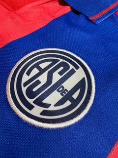 Camiseta Atomik de San Lorenzo Titular Número 10 LPF 2025 - Lírico Showroom - Tienda Online de Fútbol 