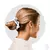A woman with a sleek hairstyle, adorned with a white satin scrunchie, showcasing the Perfect Night Pearl Kit from ZERO FRIZZ.