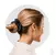 Mulher com cabelo preso em um coque, usando um scrunchie de cetim preto da marca ZERO FRIZZ®.