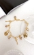 PU91177 - PULSEIRA CORAÇÃO CADEADO COM MINI CORAÇÕES CRISTAIS - FOLHEADO A OURO na internet