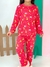 Menina sorridente vestindo pijama básico infantil vermelho com estampas de lua, estrelas e nuvens