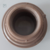 Adaptador flange para caixa d'água na cor marrom, com detalhes de rosca visíveis.