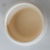 Cap Tampão 50 Krona em recipiente branco, mostrando o interior cremoso e de cor clara.
