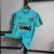 Camisa de futebol do Santos, cor azul, com logo da Nike e patrocinadores visíveis.