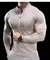 Camiseta esportiva masculina de manga comprida, modelagem justa, cor bege, com zíper e bolso frontal.