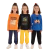Três crianças vestindo conjuntos de roupa coloridos, com estampas divertidas, representando moda infantil.
