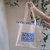 Ecobag Algodão Cru com Bolso Frontal - Olho Grego - comprar online