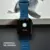 Imagem do Smartwatch N10 Slim 45mm com tela AMOLED 2.01”, mostrando o relógio com pulseira azul e mostrador de controle de câmera