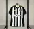 Camisa Atlético Mineiro I 25/26 Adidas. Preta e branca com patrocínio H2BET. Tecido respirável e design moderno. Personalize e frete rápido. Compre já!

