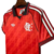Camisa vermelha do Flamengo 24/25, modelo torcedor masculino da Adidas, exibindo o escudo do time e detalhes em preto.
