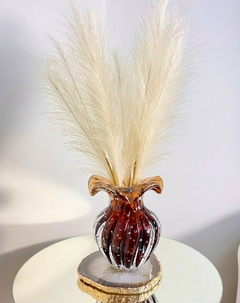 trouxinha em murano marrom com pampas beges e platter de ágata marrom natural na mesa de canto com espelho