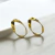 BRINCO OVAL FITA LISO DOURADO