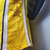 Camiseta regata amarela do Los Angeles Lakers, com detalhes em estrelas e design esportivo.