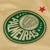 Logotipo do Palmeiras em destaque na camisa dourada, com detalhes em verde e uma estrela vermelha