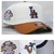 Boné New Era branco com aba marrom, estampado com o logo "LA" e detalhes do 100º aniversário dos Dodgers.