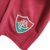 Emblema do Fluminense em um kit infantil de cor branca e detalhes em vermelho.