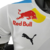 Camisa masculina branca da Red Bull para a temporada de Fórmula 1 23/24, com logotipos da Red Bull e Puma.