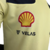 Camisa masculina verde da Ferrari 23/24 com logo da Shell e Velas.