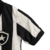 Camisa do Kit Infantil Botafogo I 23/24 da Reebok, nas cores preta e branca, com detalhes do escudo do clube.