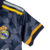 Camisa do kit infantil do Real Madrid 23/24 da Adidas, na cor azul com detalhes em amarelo e branco.