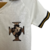 Camisa infantil branca do Vasco II Kappa 22/23 com detalhes em dourado e preto, apresentando o escudo do time.