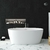 Banheira Freestanding Imersão Viena 150 Branco em ambiente moderno com parede escura e piso de mármore.