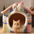 Camita en forma de casita de conejito, con orejitas en la entrada y conejitos impresos en la pared. Con gatito en la entrada.
