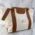 BOLSO LISO CON AZA RÍGIDA BASILEA