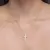Colar cruz cravejada de zircônias banhado a ouro 18K na internet