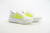 Tênis Adidas Ultraboost 5 na cor branca com detalhes em verde neon, exibindo design moderno e solado confortável disponível na Supernova Sneakers