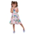 Menina sorrindo usando um vestido infantil colorido com estampas de estrelas e arco-íris.