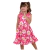 Vestido infantil rosa com flores brancas e amarelas, usado por uma menina sorridente.