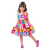 Menina vestindo um vestido infantil colorido com estampas divertidas, exibindo um sorriso.