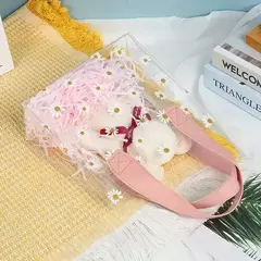 Bolsa pvc cristal con margaritas y manija de cuerina rosa. Precio x unidad.