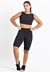 Conjunto fitness preto com cropped e bermuda, modelo feminino em pose frontal.