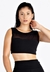 Cropped fitness preto com detalhe em transparência, modelo feminino.