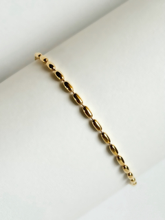 Pulseira dourada capsulas