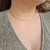 Choker liso anatômico Anelise banhado a ouro na internet