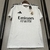 Camisa do Real Madrid I 24/25, modelo torcedor da Adidas, na cor branca com detalhes em preto.Camisa Real Madrid I 24/25 - Torcedor Adidas Masculina - Branca com detalhes em preto