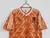 Camisa retrô laranja da seleção da Holanda de 1988, fabricada pela Adidas, com detalhes em branco e logo da marca.