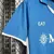 Camisa do Napoli Home 2024-25, azul, com logotipo EA7 e MSC, destacando o design esportivo.